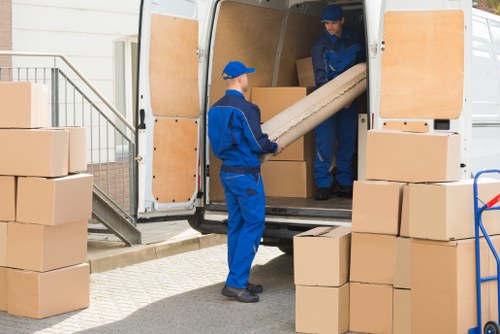 Removal company team handling boxes in Westkensington