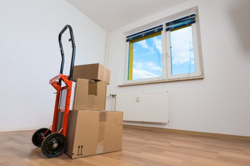 Removal staff wearing PPE while carrying furniture