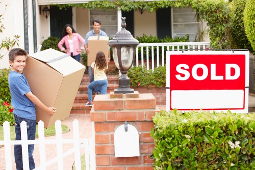 Moving team organising boxes and household items in West Kensington